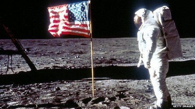 Edwin 'Buzz' Aldrin - the second man to walk on the moon - poses next to the US flag, July 1969