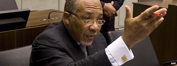 Former Liberian President Charles Taylor (L) waits on 8 February 2011 for the start of the prosecution's closing arguments during his trial at the UN Special Court for Sierra Leone
