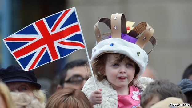 A young girl wears a homemade crown as she waits to see Queen Elizabeth II visit the town centre of Accrington as part of the Queen's Diamond Jubilee tour of the country on 16 May 2012