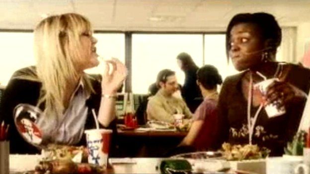 Two women eating at a call centre in a 2005 advert for Yum! Restaurants (UK) Ltd
