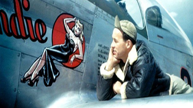 USAAF serviceman Don Allen admires 'Blondie' from the wing of a bomber plane
