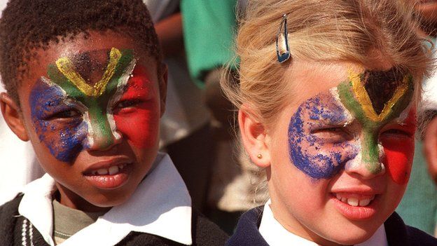 South African girls with their faces painted in the colours of the national flag, pictured in 1996, two years after the end of apartheid