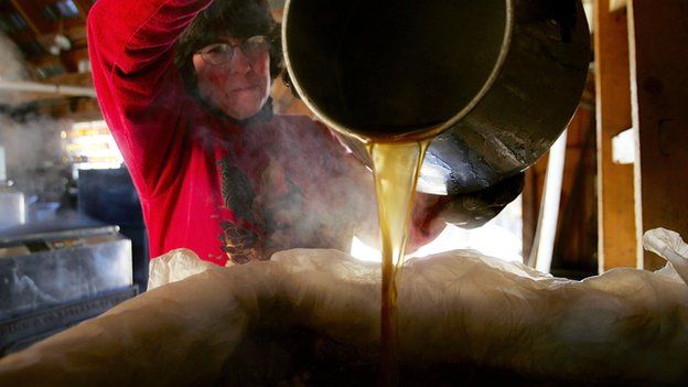 A woman pours maple syrup into a tank in Bowdoin, Maine (file image from 2006)