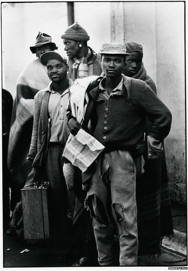 Pensive tribesmen, newly recruited to mine labour, awaiting processing and assignment by Ernest Cole