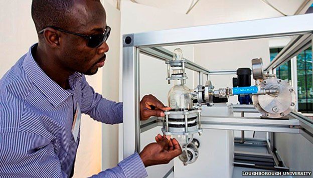 Eric Danso-Boateng, PhD student in Loughborough University's chemical engineering department, makes adjustments to their prize-winning prototype loo