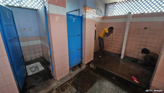 Men washing in a toilet at a railway station in New Delhi