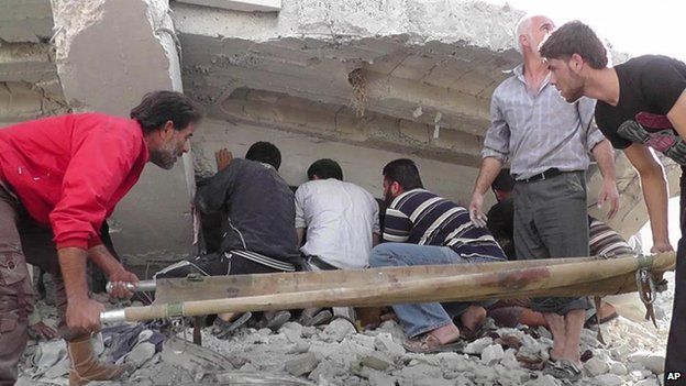 Syrian citizens search under rubble to rescue people from a building that was destroyed after an air strike in Idlib province, northern Syria, 17 October 2012 (image provided by Idlib News Network and authenticated based on its contents and other AP reporting)