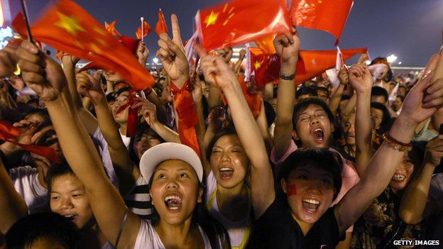 Chinese crowd in Beijing waving flags