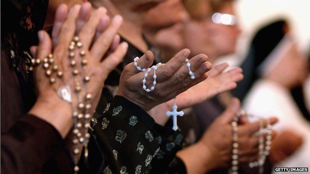 Women holding rosaries