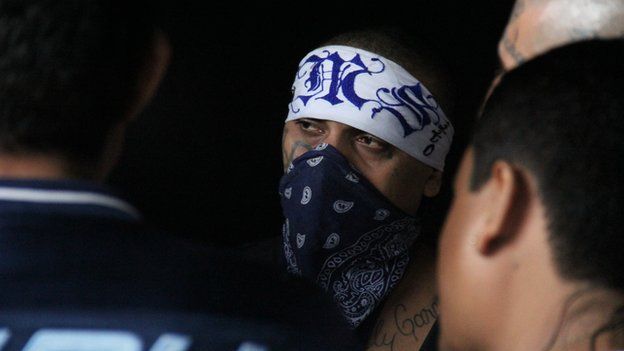 A Mara Salvatrucha leader with a bandana covering his face