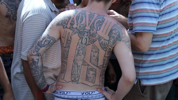 An 18th Street gang member with a tattooed back