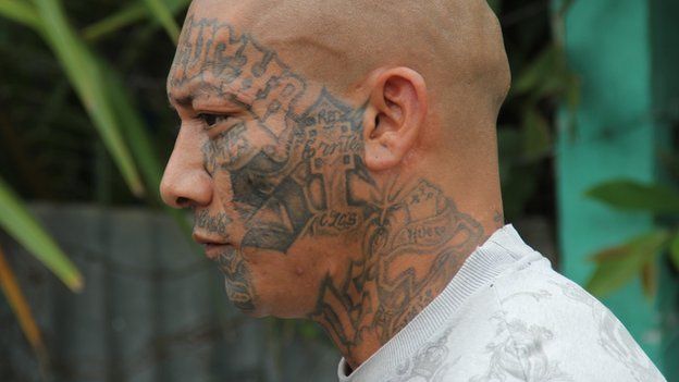 A Mara Salvatrucha gang member with a tattooed face