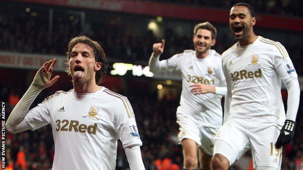 Michu celebrates his first goal against Arsenal, with Angel Rangel showing his delight in the background