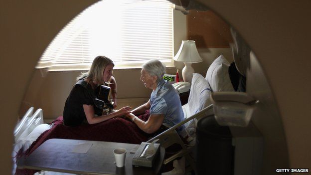 A terminally ill hospice resident with her music therapist in Lakewood, Colorado in the US