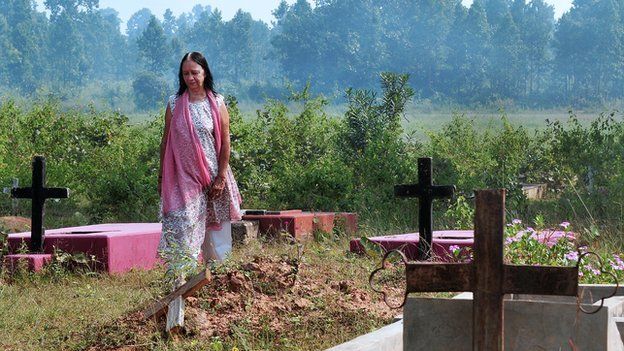 A 60-year-old Anglo-Indian resident of McCluskieganj, in eastern India, walks through a Christian cemetery in October 2011.
