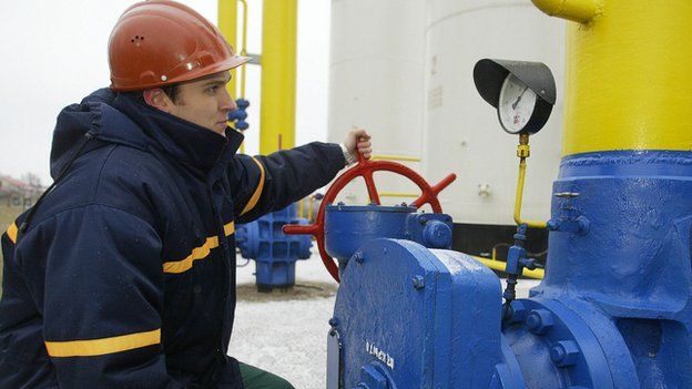 Ukrainian engineer using gauge at Ukrtransgaz gas compressor station