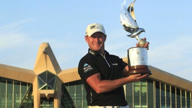 Jamie Donaldson proudly displays the Abu Dhabi Championship trophy