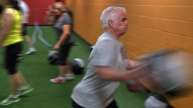 Man exercises with medicine ball