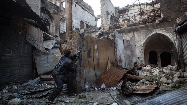 A Syrian rebel prepares for battle in Aleppo