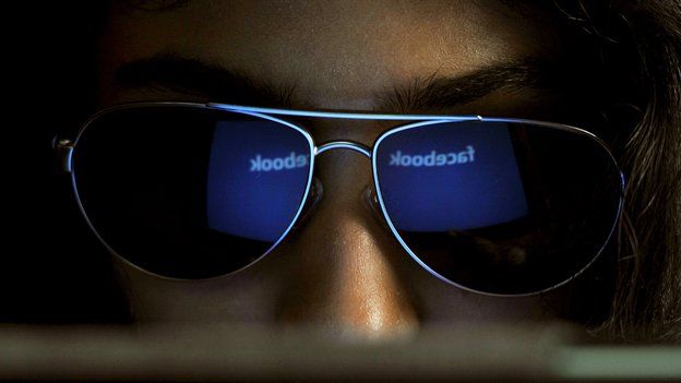 Facebook website reflected in the sunglasses of an India woman
