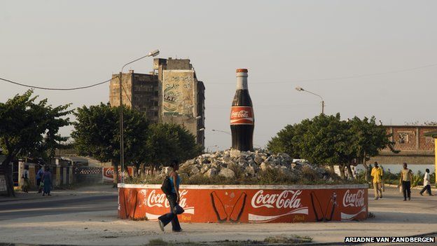 Coca Cola bottle advertisement in centre of roundabout in Maputo