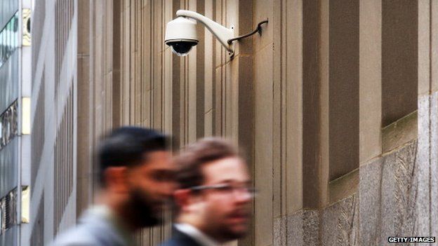 Men walk in front of an outdoor camera