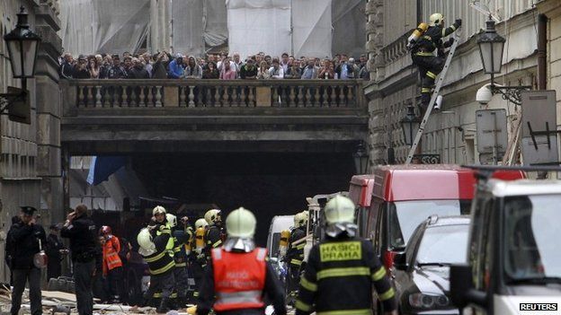 People look on as emergency services attend the scene