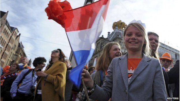 Woman waving national flag in Amsterdam (30 April 2013)