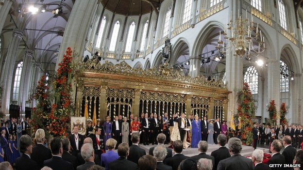HM King Willem-Alexander of the Netherlands and his wife HRH Princess Beatrix of the Netherlands stand with members of the royal household during their inauguration ceremony at Amsterdam's New Church, 30 April 2013