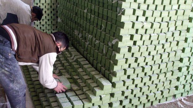 Workers stacking soap