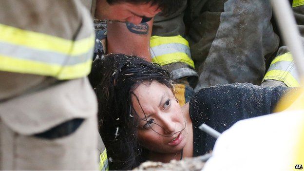 A woman is pulled out from under tornado debris at the Plaza Towers School