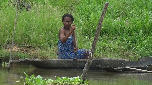 A woman in a canoe in the Niger Delta