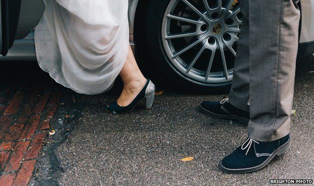 Details of the bride and groom's feet as they get into the wedding car