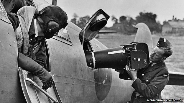 Camera being loaded into an aircraft