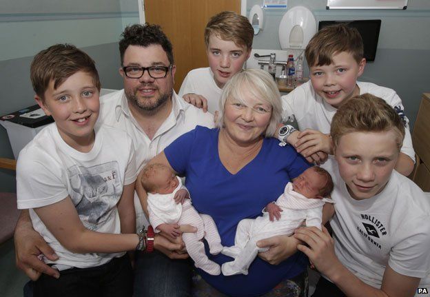 Karen Rodger who defied the odds by becoming pregnant with her third set of twins is pictured holding her newborns Rowan (left) and Isla (right) with with husband Colin Rodger (2nd left) and their sons left to right Finn, Lewis, Jude and Kyle at the Southern General Hospital in Glasgow.
