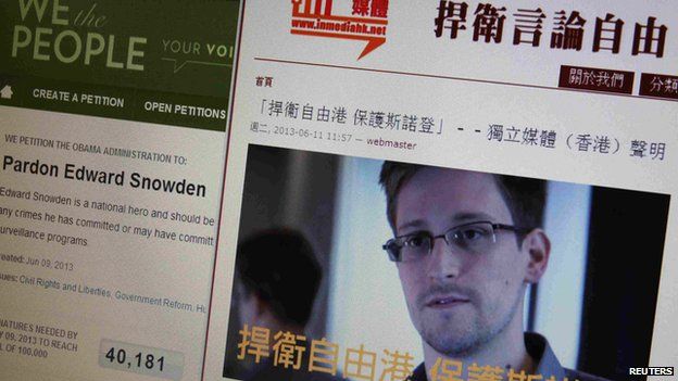 A statement by Hong Kong online media In Media Hong Kong supporting Edward Snowden is displayed alongside a petition to Pardon Edward Snowden on a White House website, on a computer screen in Hong Kong on 12 June 2013