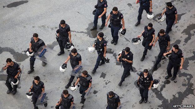 Riot police pass Taksim Square in Istanbul, 16 June