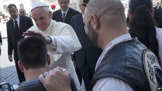 Pope Francis blesses a person in Harley Davison garb on St Peter's Square, 16 June