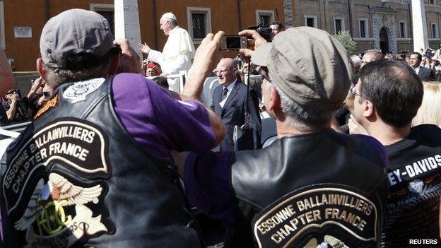 Bikers strain to photograph Pope Francis on St Peter's Square, 16 June