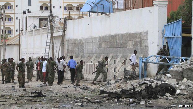 Somali government soldiers arrive to secure the United Nations compound following a suicide bomb attack in the capital Mogadishu, 19 June 2013