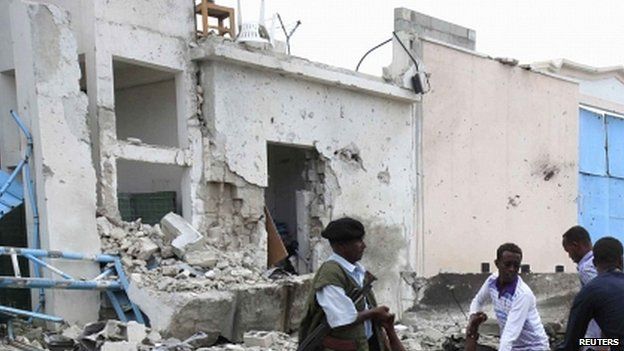 Somali government soldiers evacuate an injured man after a suicide bomb attack inside the United Nations compound in the Somali capital Mogadishu, 19 June 2013