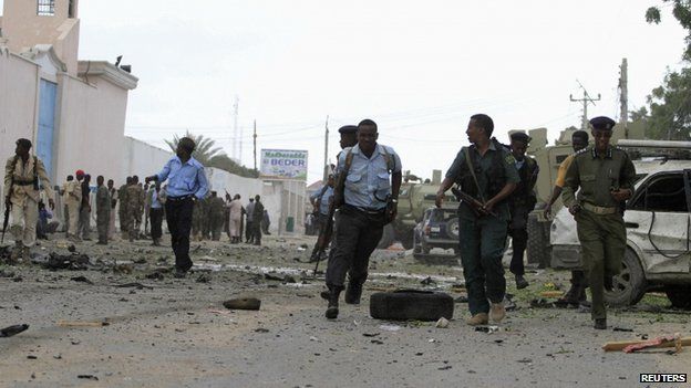 Government soldiers arrive to secure the United Nations compound following a suicide bomb attack in the capital Mogadishu, 19 June 2013