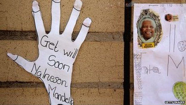 Children's get-well wishes are taped to the wall outside the Mediclinic Heart Hospital where Nelson Mandela is being treated on 22 June 2013