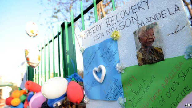 Balloons and letters wishing former South African President Nelson Mandela well are displayed at the entrance of the Medi-Clinic Heart Hospital on 24 June 2013 in Pretoria