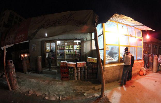 A baker and grocery store in Kabul at night