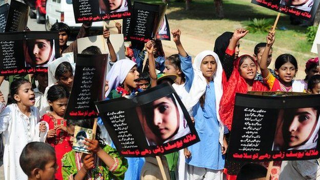 File photo of Pakistani children hold up posters of Malala Yousafzai (10 November 2012)