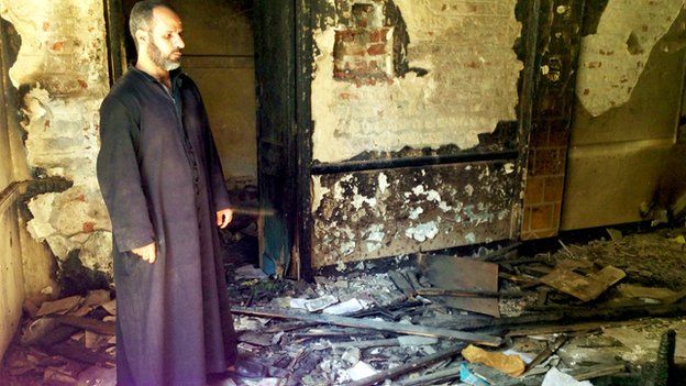 Father Ayoub Youssef in his burned-out church