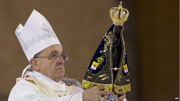 The Pope holds a statue of Our Lady of Aparecida, the patron saint of Brazil, during his Mass in Brazil