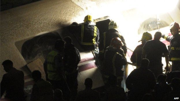 Recue workers search inside of train carriage after train derailed near city of Santiago de Compostela on 24 July 2013