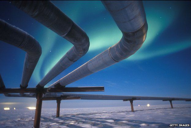 Alaska pipeline with background of Northern Lights